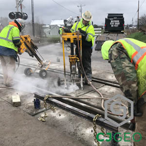 CJGeo polyurethane grouting crew members using a pneumatic drill