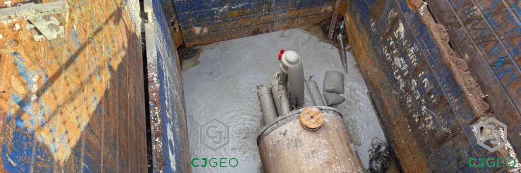 CJTherm thermal grout venting out of the far end of a microtunnel inside an excavation supported by trench boxes.