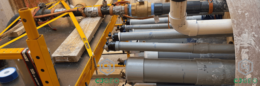 Multiple PVC conduits extending from the end of a tunnel inside of a shaft on a CJGeo thermal grouting project.