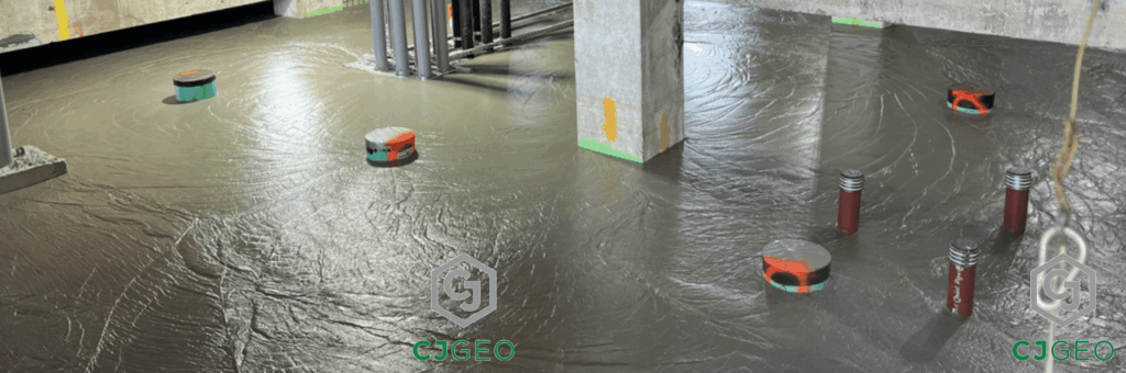 CJFill-Standard cellular concrete poured around pipes and columns in a basement.