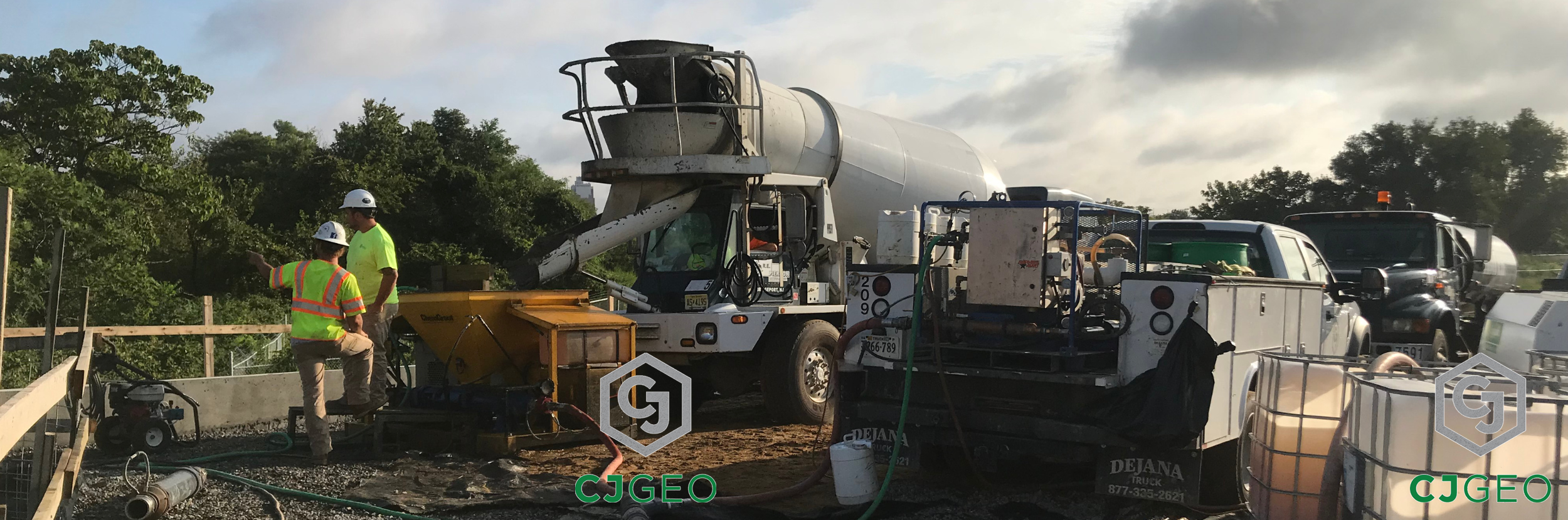 a front discharge ready mix truck discharging grout into a pump on a construction site