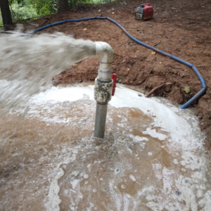 Water being blown out of a pipe, using cellular grout.