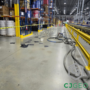 hoses and equipment on the floor of a large warehouse