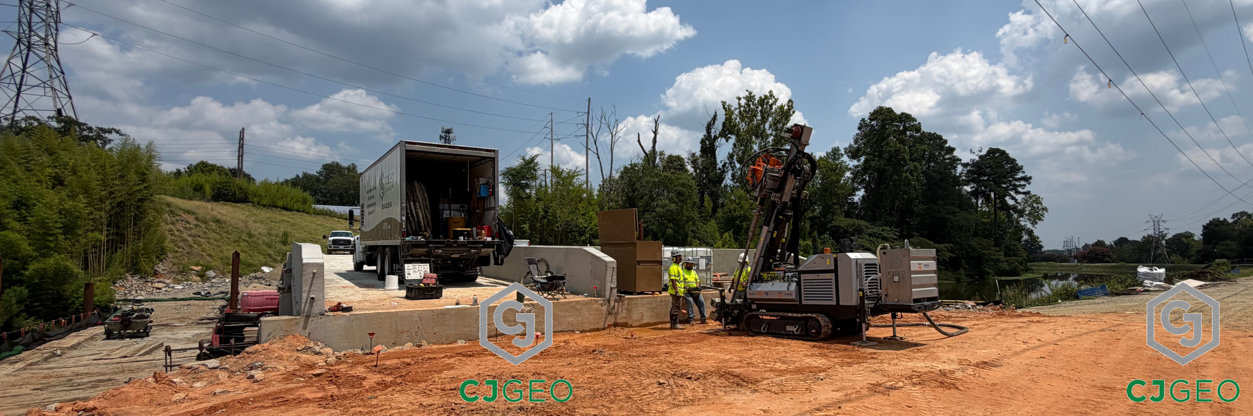 A sonic drill and polyurethane grouting equipment sitting adjacent to a bridge over a canal.