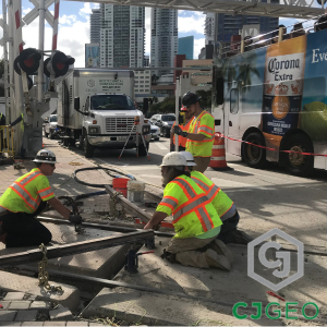 Workers repairing a modular grade crossing.