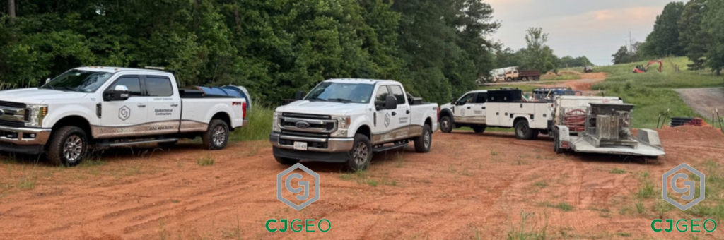 CJGeo pickup trucks and cellular grouting equipment on a dirt road in a power line right of way