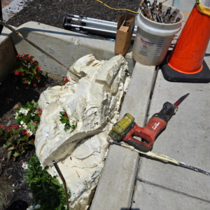 polyurethane grout and hand tools next to a sidewalk