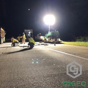 workers lifting an interstate slab with polyurethane grout at night